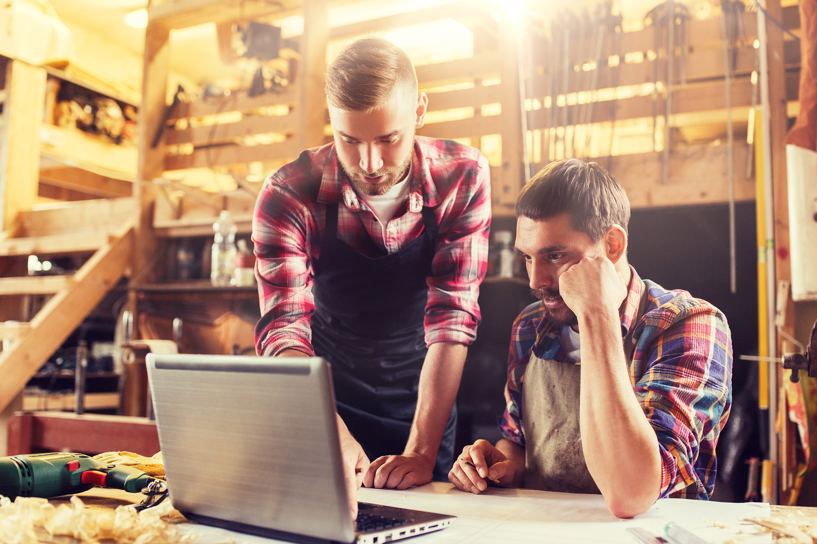 profession, carpentry, technology and people concept – two carpe Arbeiter suchen online nach Leasing-Angeboten für eine Holzbearbeitungsmaschine
