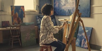 Woman sitting on a chair and painting
