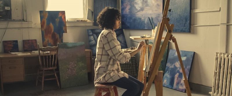 Woman sitting on a chair and painting